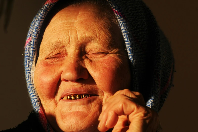 a woman that has a beaded smile and wears a scarf