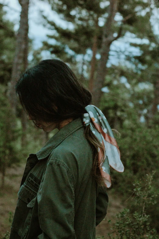 a girl standing outside while wearing a jacket