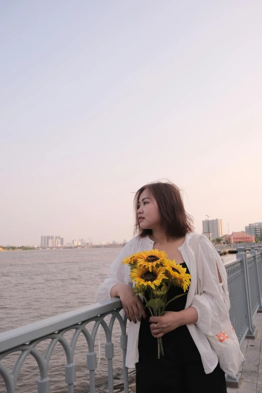 a woman standing on the edge of a pier