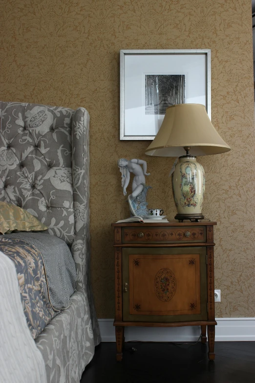 a lamp and a mirror are sitting on a table near the bed