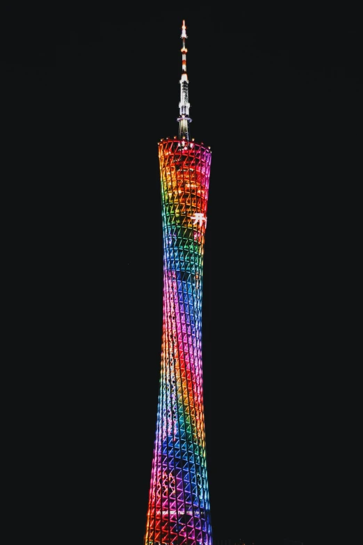 the tower is tall and lit up all of it's multicolored lights