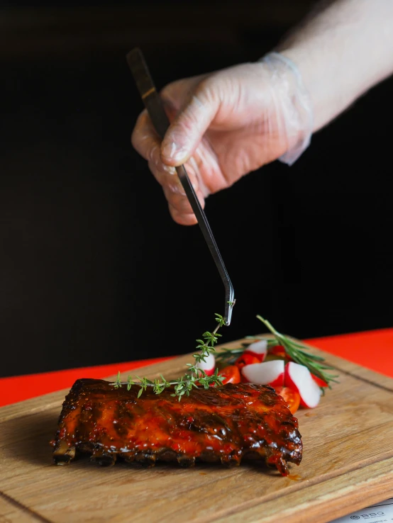 a person  into some food on a  board