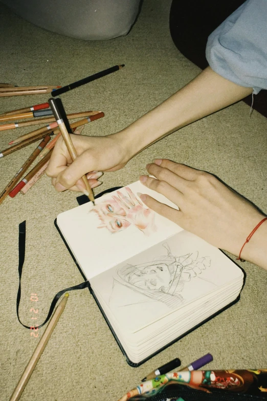 a woman drawing a line with colored pencils