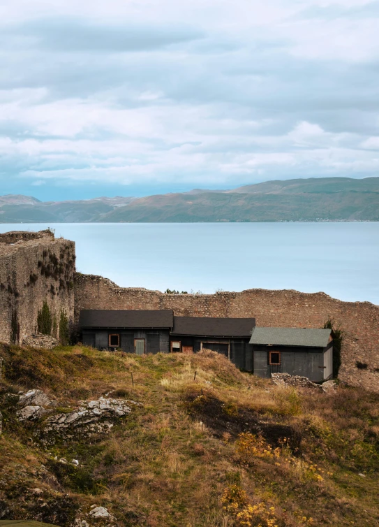 a picture of a small house sitting on top of a hill