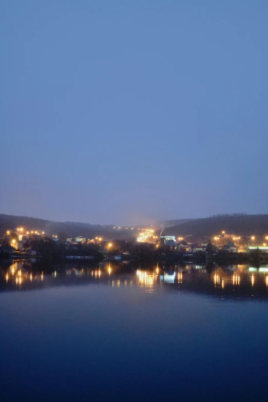 a night view of a body of water with lights on