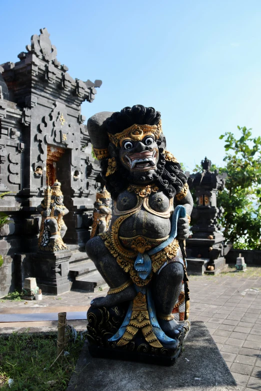 a statue sitting in front of a very old structure