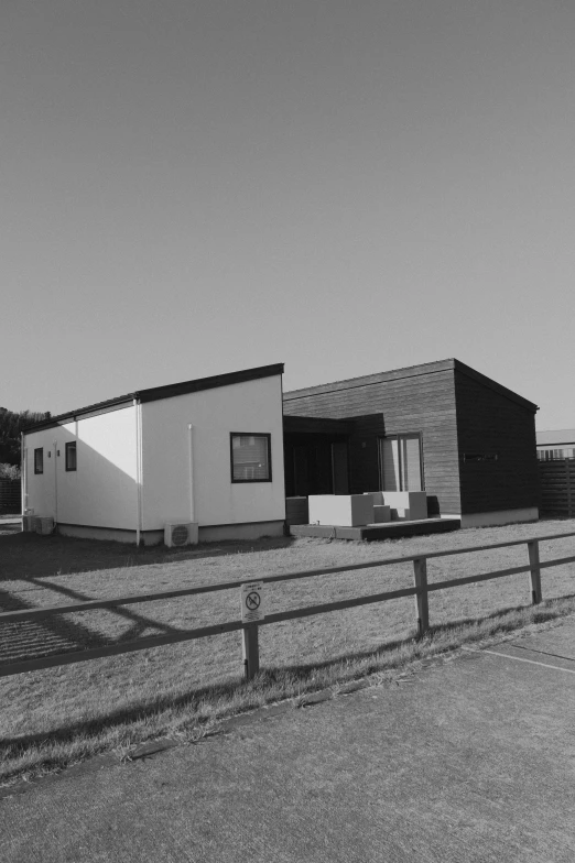 there is a black and white po of a fence and building