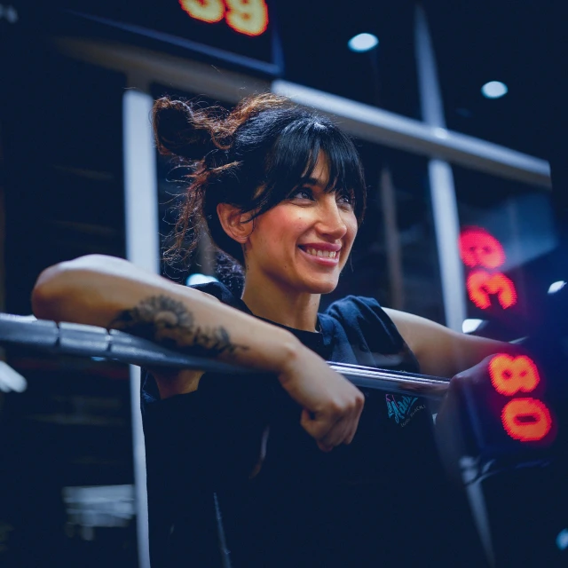 a woman smiles at the camera behind bars