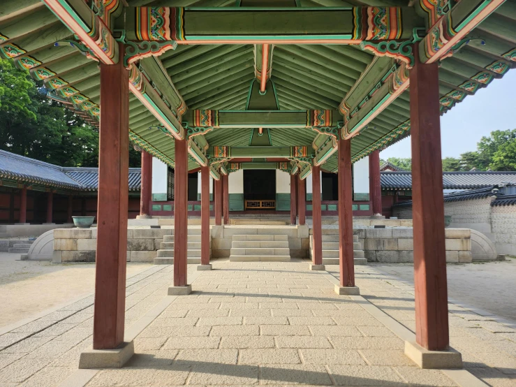 the interior of an old japanese pavilion with pillars