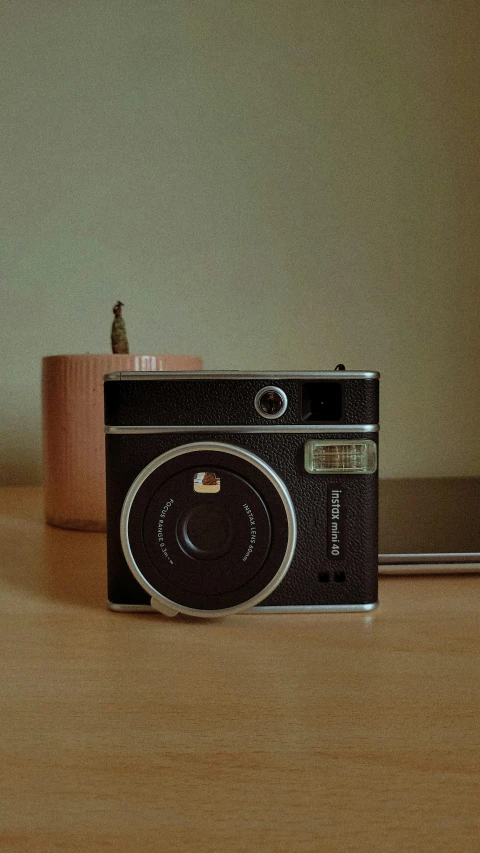 an old - fashioned camera, still sitting on a table