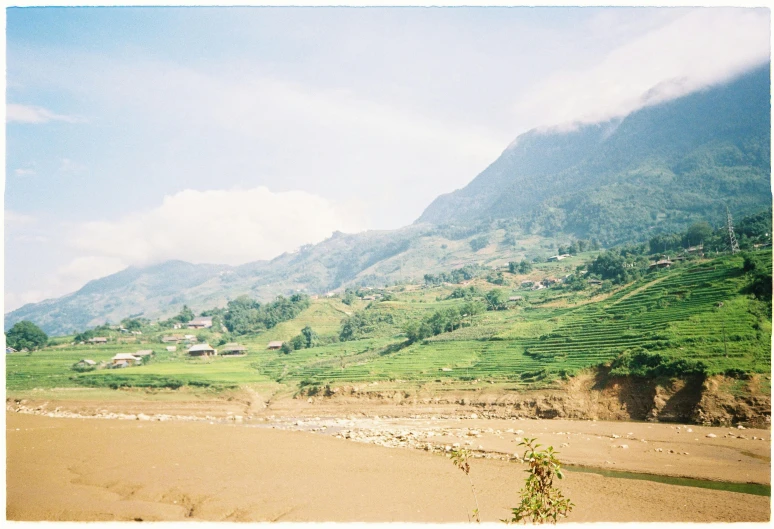 a large hill that has a grassy valley in the background