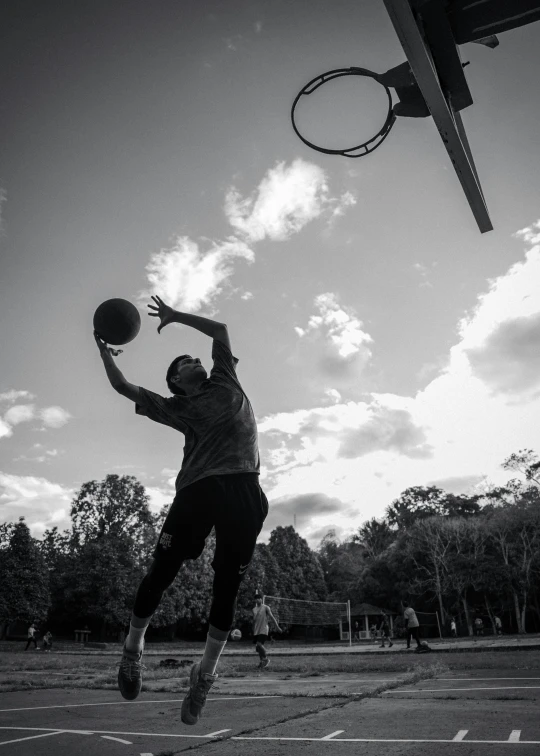 a man is jumping to dunk a basketball in the air