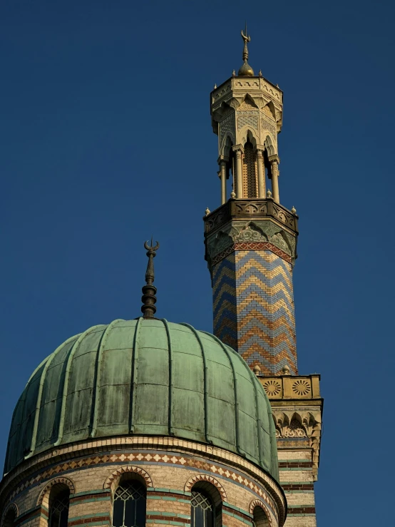 a brick tower and blue sky behind it