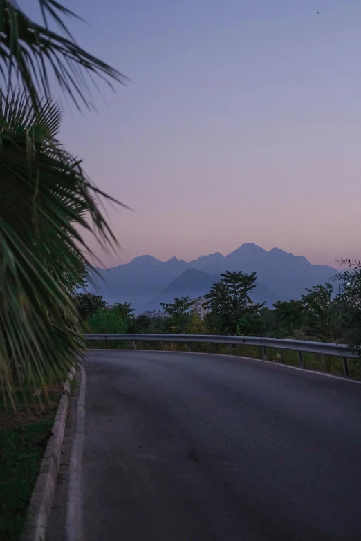 the motorcycle rider rides down the street at night