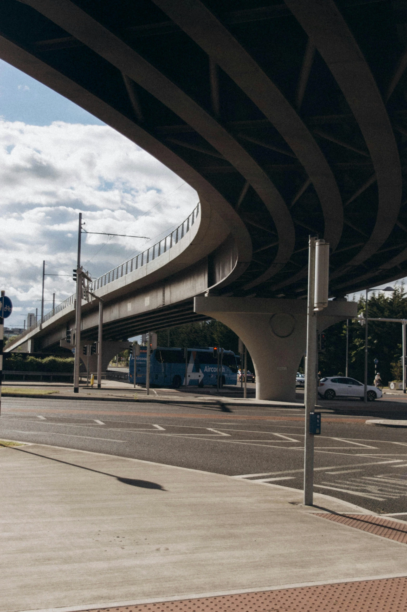 traffic light and pedestrian walkway going under an overpass