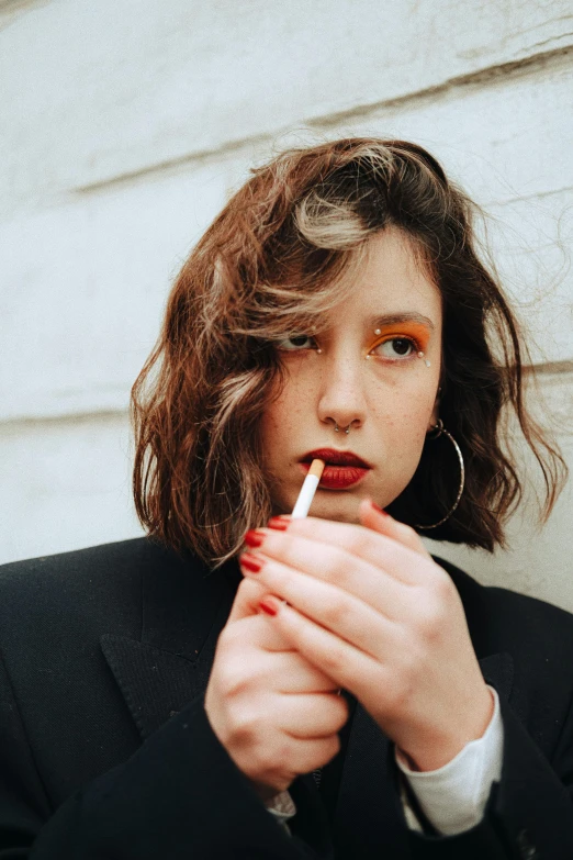 a woman that is smoking and has a cigarette