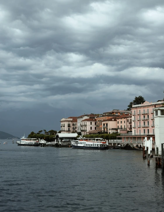 a body of water next to buildings and a pier