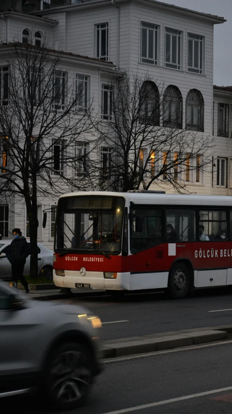 the public bus is traveling down the city street