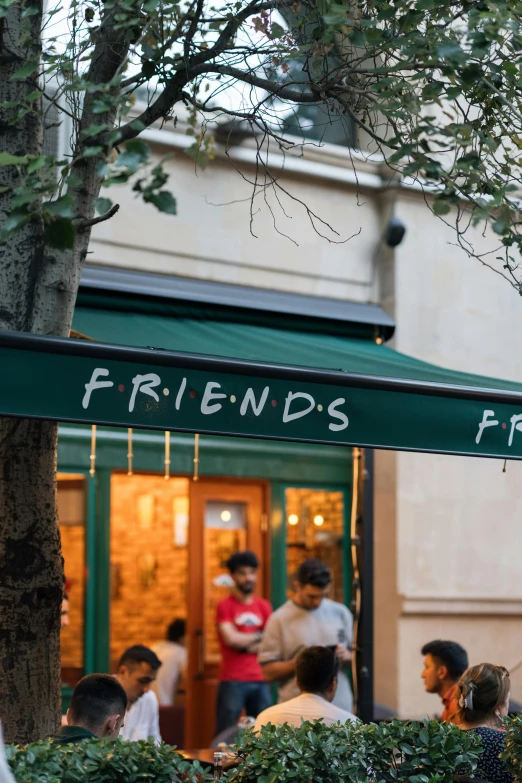 a shop with people outside and their name on it