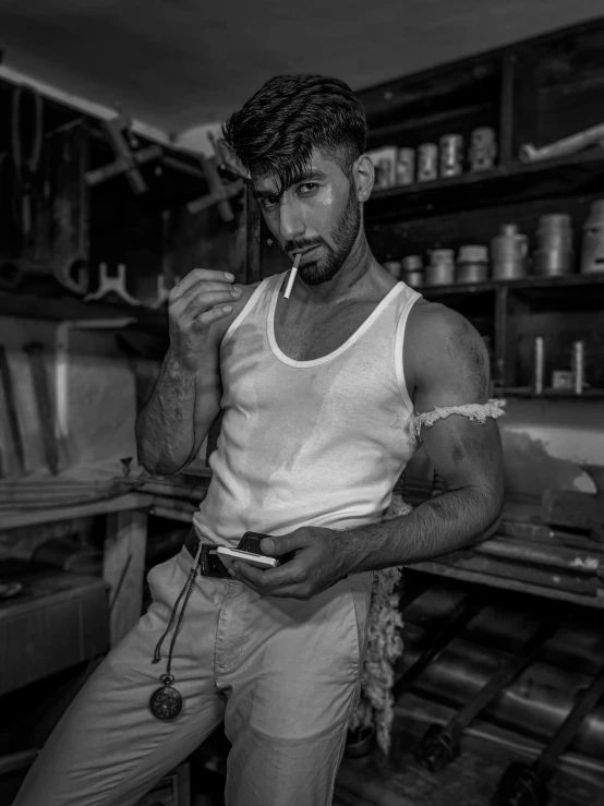 a man wearing a vest and holding a cigarette while standing in a store