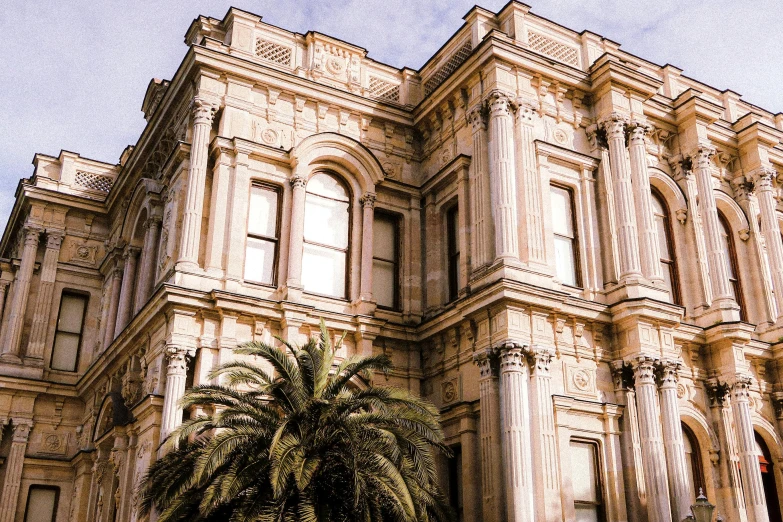 an old, stone building with palm trees in front