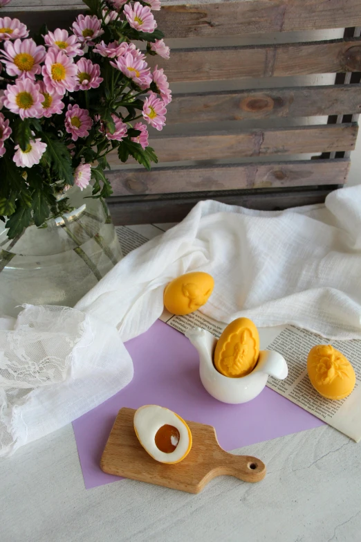 there are some eggs and an egg spoon on a tray