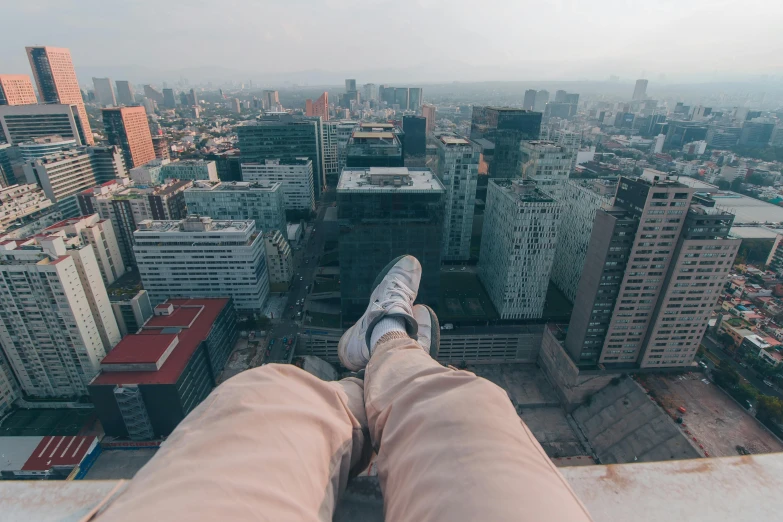 the man has his feet up high above the city