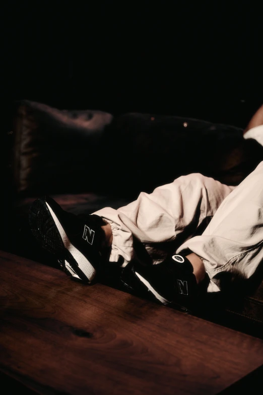 a person laying down on top of a brown table