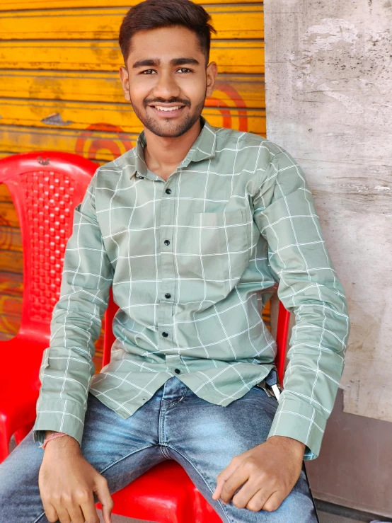 a man is sitting in the middle of some chairs