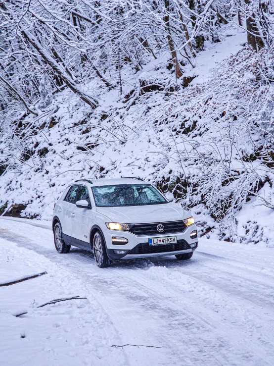 a car driving down the street with snow all around