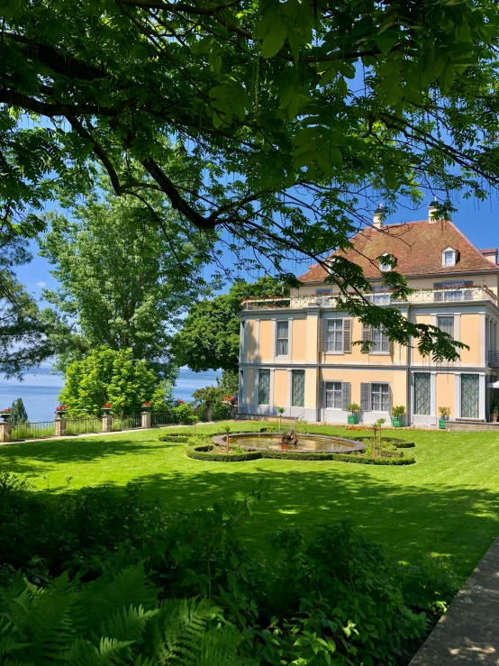 an ornate building next to some trees and shrubs