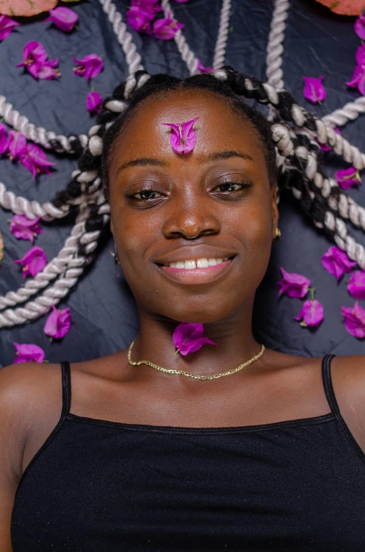 a woman with flowers in her hair smiling