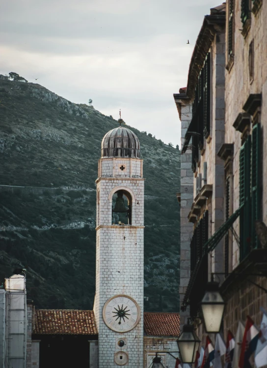 a white clock tower with a sky background