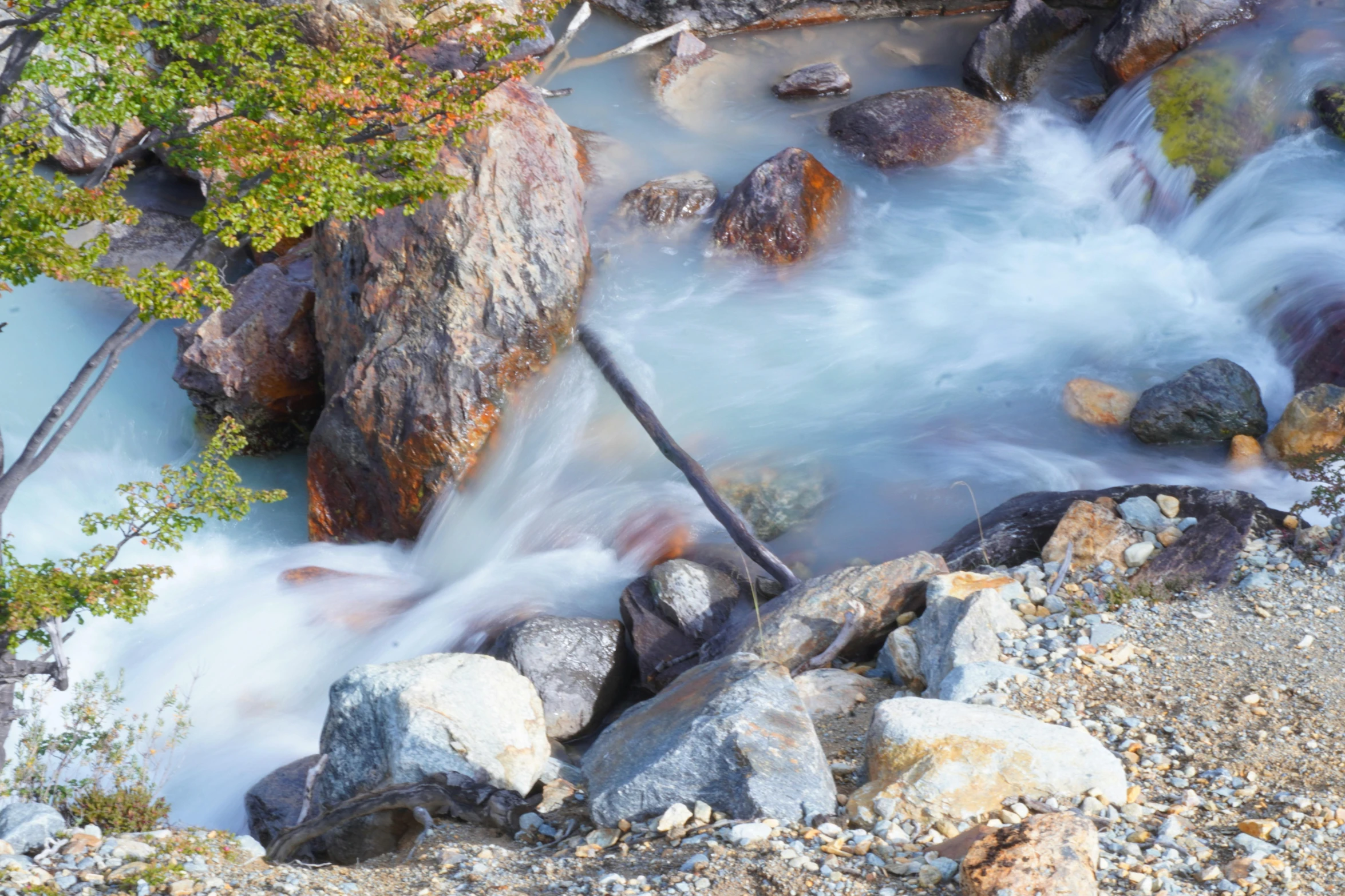 a river flowing over rocks on a trail