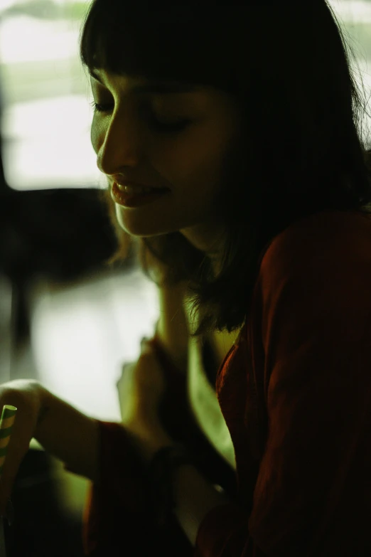 a woman looks down at her cell phone