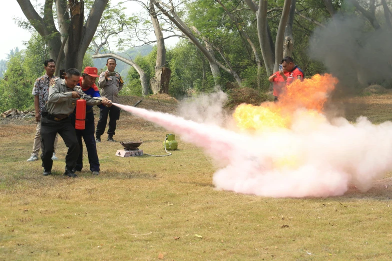 several people standing around a fire hose