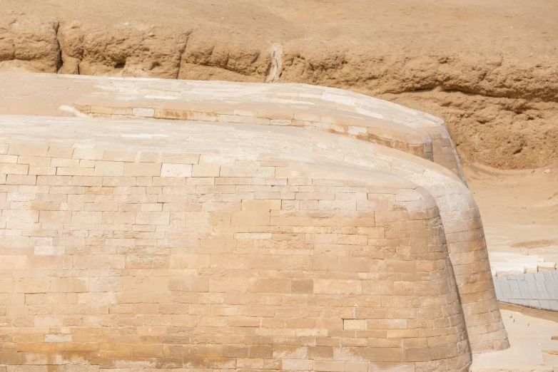 a person is sitting on top of an elephant that's in a sandy area