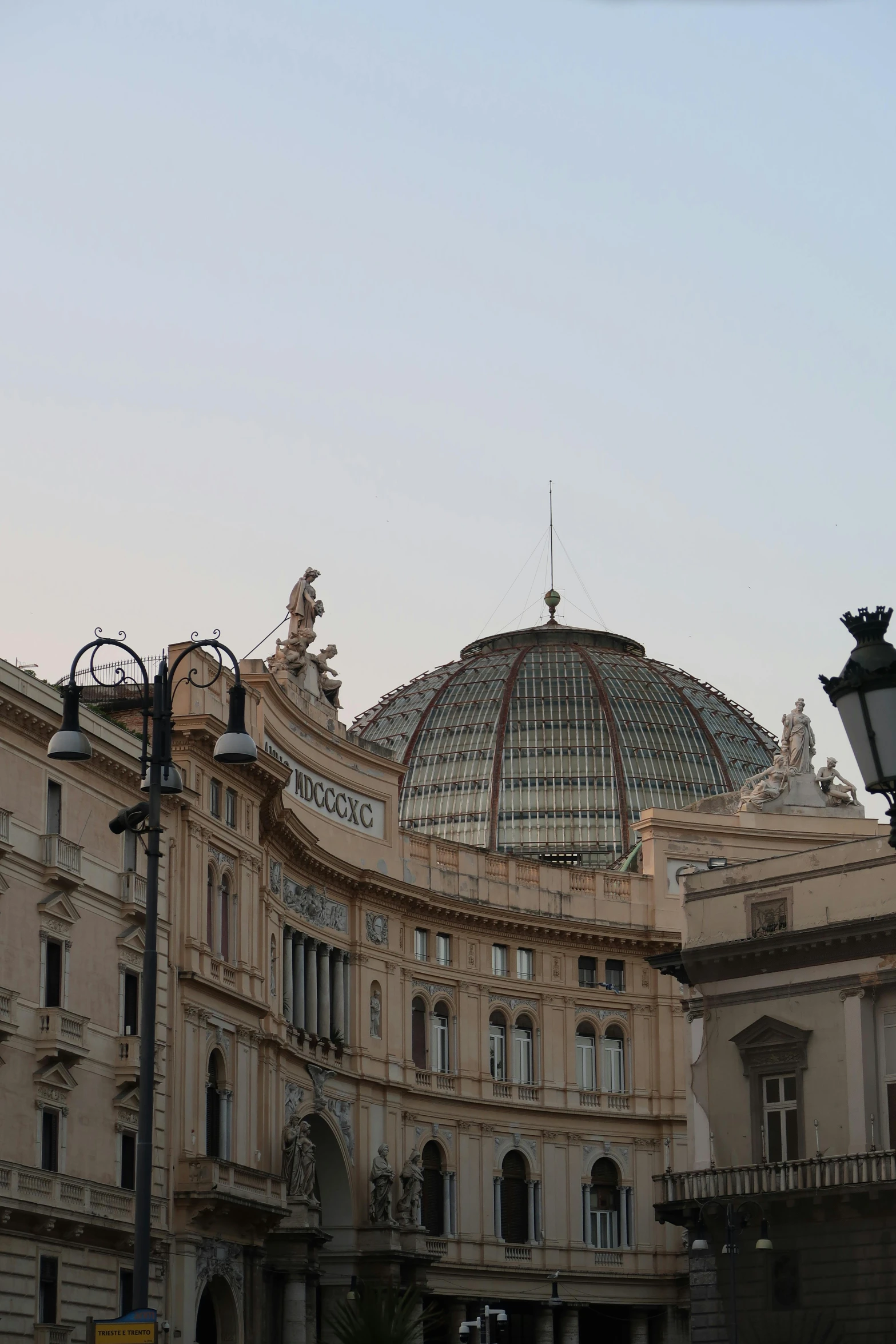 a very tall building with some statues on it's front