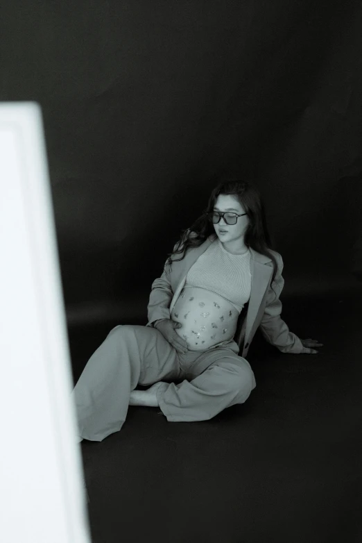 woman sitting in the corner with black and white po