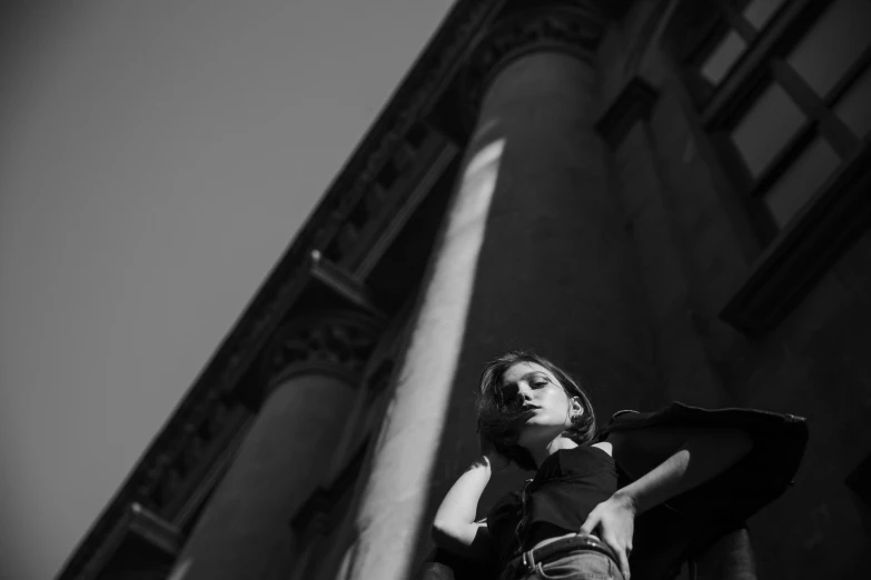 young woman posing outside in front of building