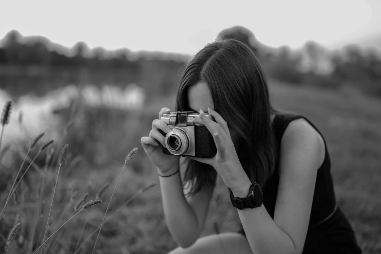 a woman taking a picture of the camera outside