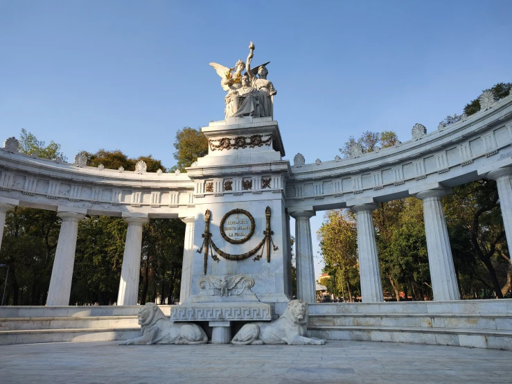 a statue of a person and a clock on a pedestal