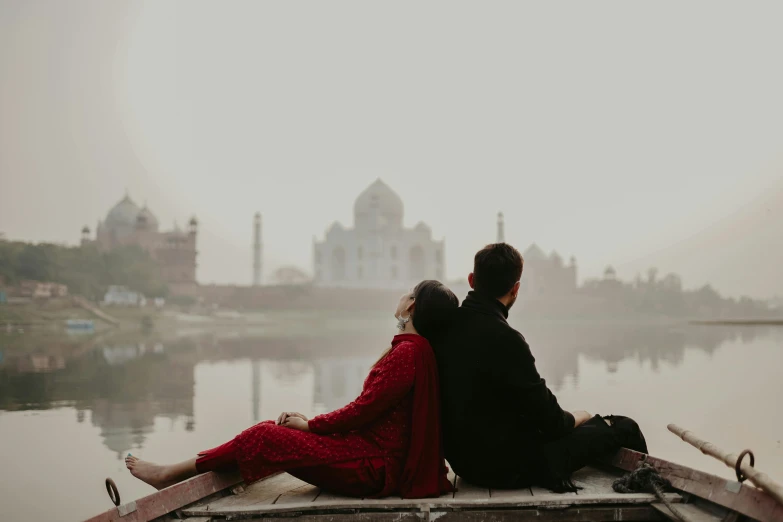 a man and woman are sitting on a boat