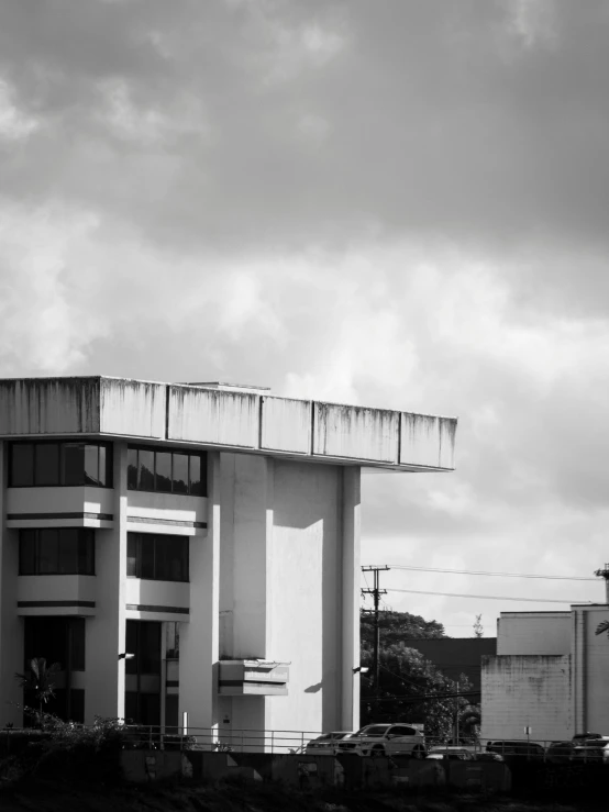 a black and white pograph of an airplane parked in front of a building