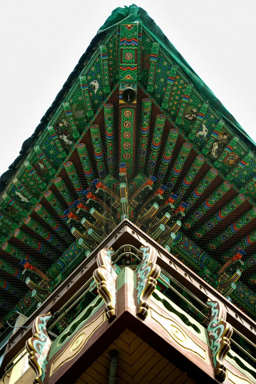 a very elaborate green building on top of a building