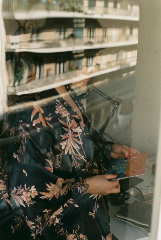 an image of woman taking a picture of a book