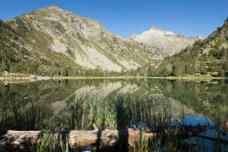 a calm lake with mountains in the background