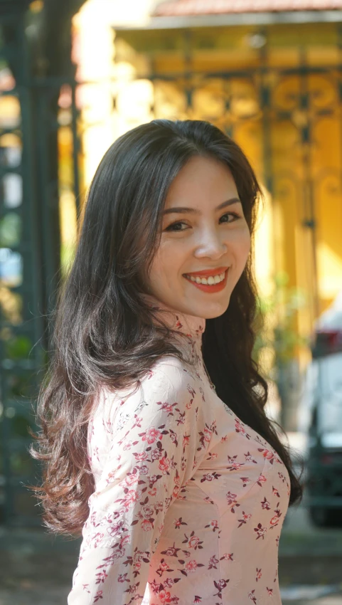 a woman with long dark hair smiling at the camera