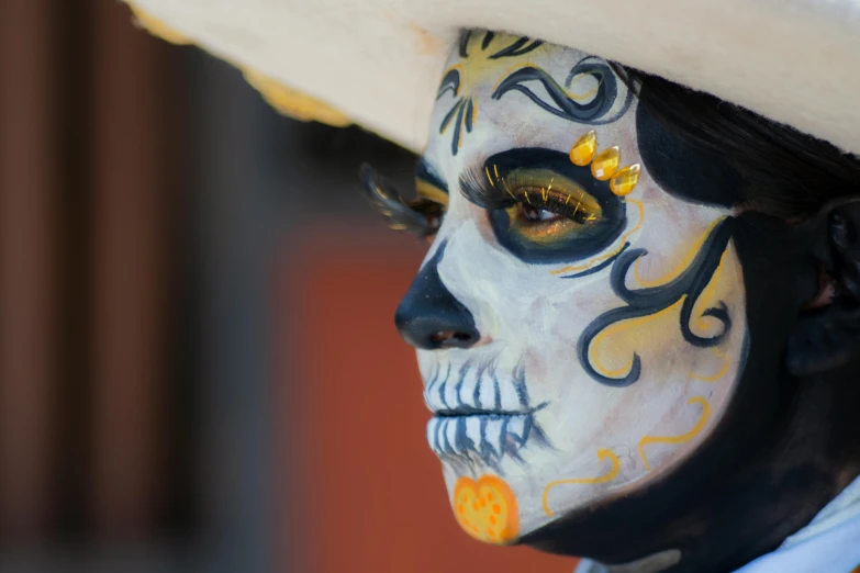 a man in face painted with a hat on