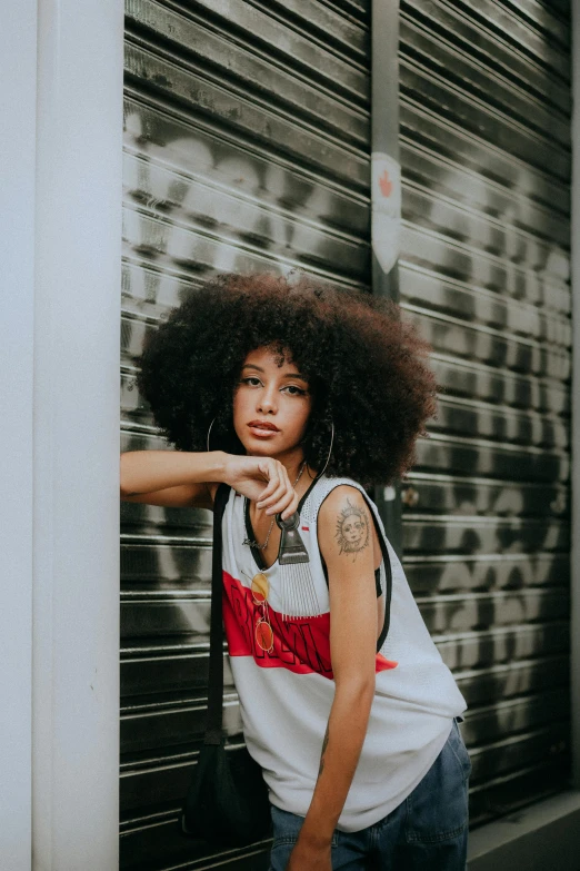 a woman with large afro pointing at the camera